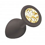 <strong>Чёрная анальная пробка Emotions Cutie Small с жёлтым кристаллом - 7,5 см.</strong> <br />
Анальная пробка конусообразной формы, выполнена из гипоаллергенного силикона и украшена красивой стразой в основании. <div class="charTableblock"><div><span>Длина, см</span>: 7.50</div><div><span>Диаметр, см</span>: 2.70</div><div><span>Материал</span>: силикон</div><div><span>Длина, см</span>: 5-8</div><div><span>Диаметр, см</span>: 2</div></div> Чёрная анальная пробка Emotions Cutie Small с жёлтым кристаллом - 7,5 см.
Анальная пробка конусообразной формы, выполнена из гипоаллергенного силикона и украшена красивой стразой в основании.